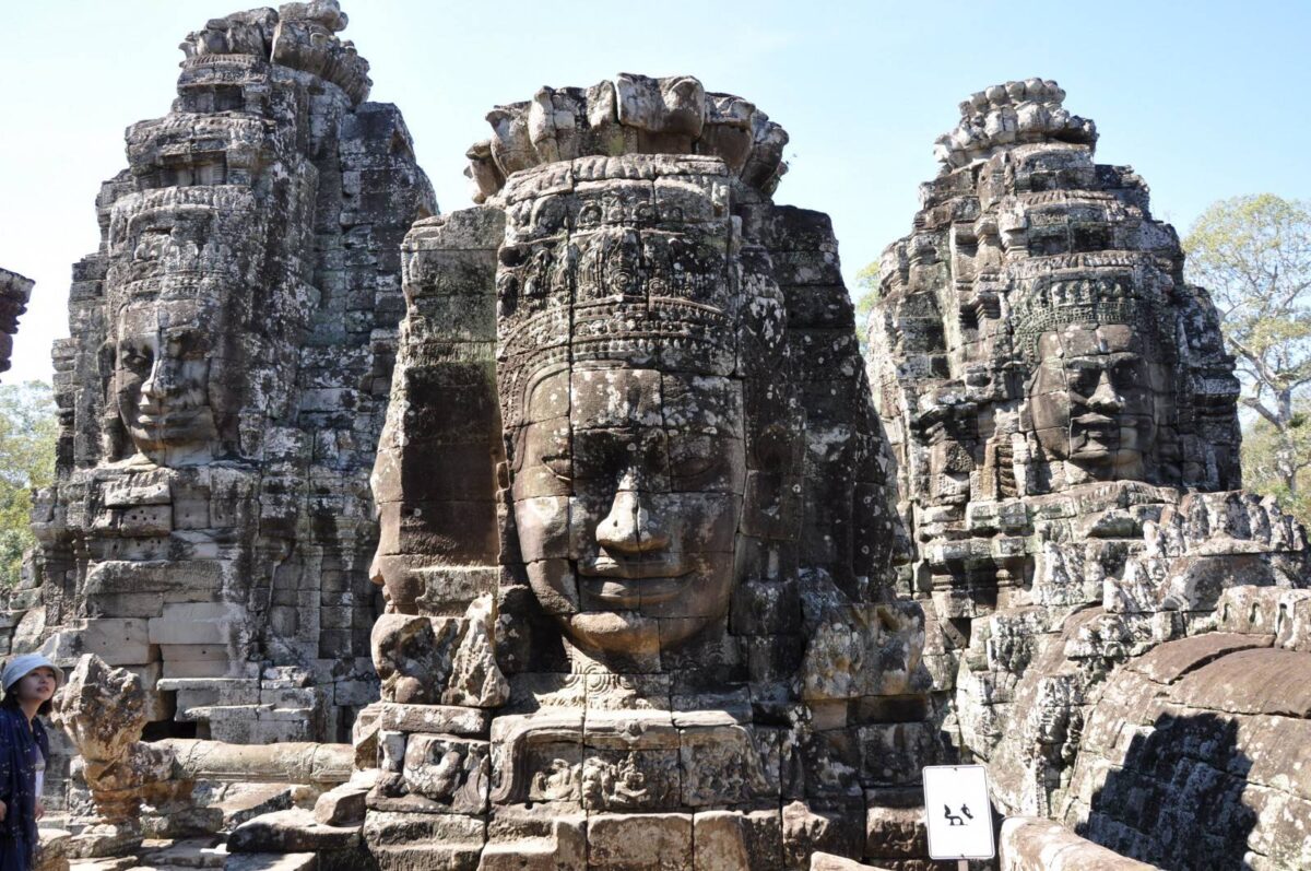 Panoramic view of Angkor Wat temple complex with reflection in the water at sunrise near Siem Reap, Cambodia