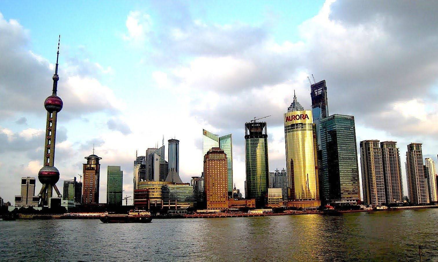 Panoramic view of Beijing city skyline with traditional rooftops and modern high-rise buildings under a clear sky