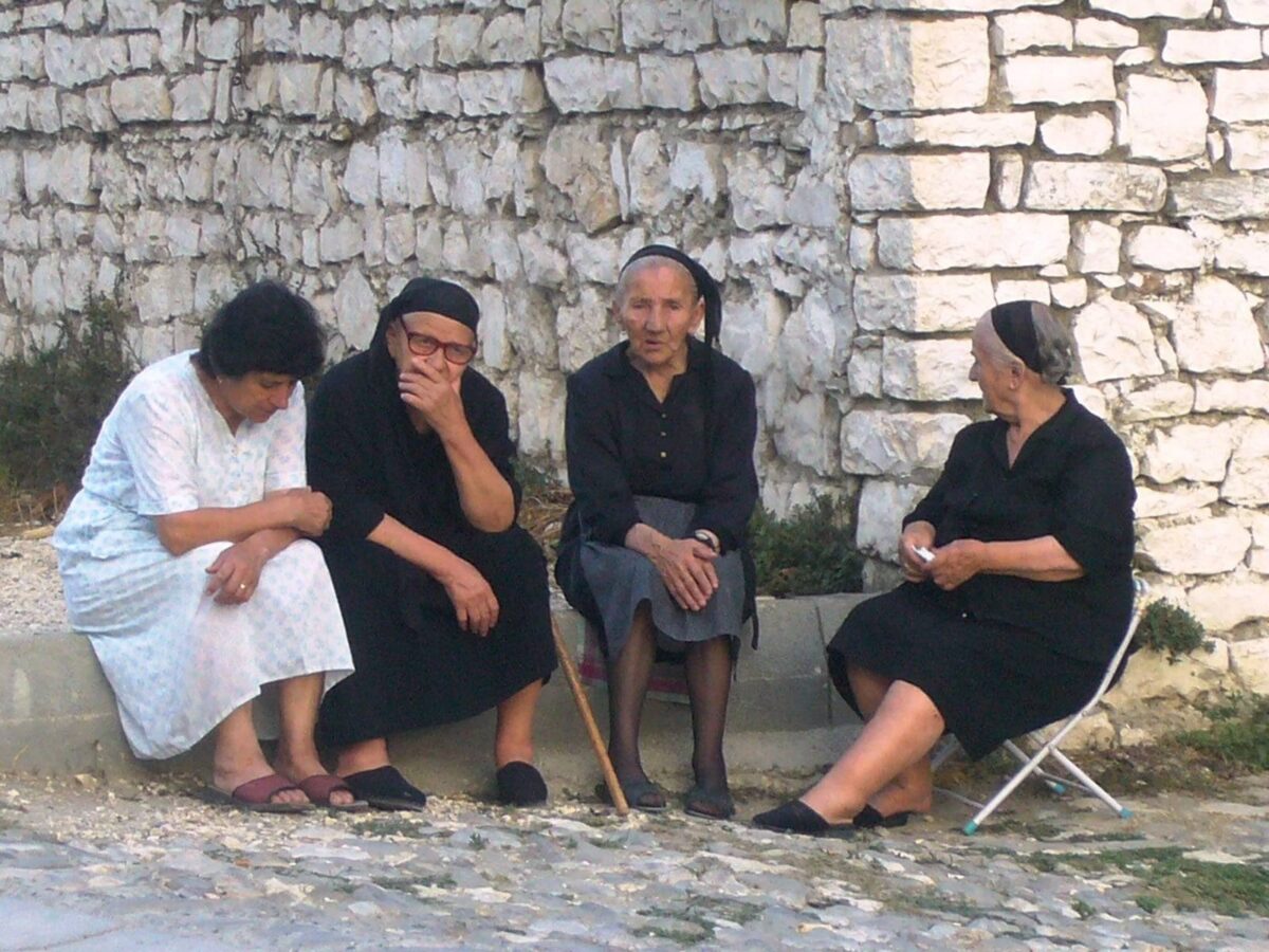 Panoramic view of Berat, Albania, with white Ottoman houses and many windows cascading down the hillside