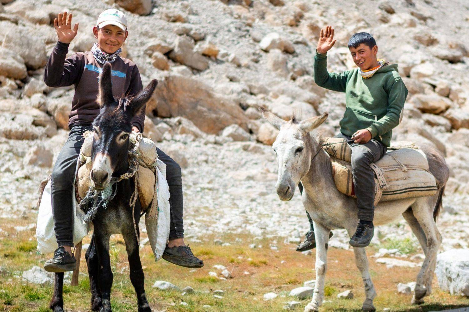Panoramic view of Cappadocia’s fairy chimneys and rock formations at sunrise with a traditional village in the foreground in Turkey