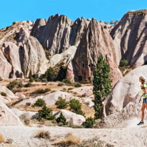 Panoramic view of Cappadocia’s rocky valleys at sunrise with volcanic formations and scattered cave dwellings