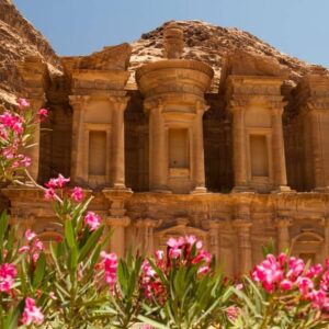 Panoramic view of Jordan’s desert landscape with red sand, rugged rock formations and clear blue sky near Wadi Rum