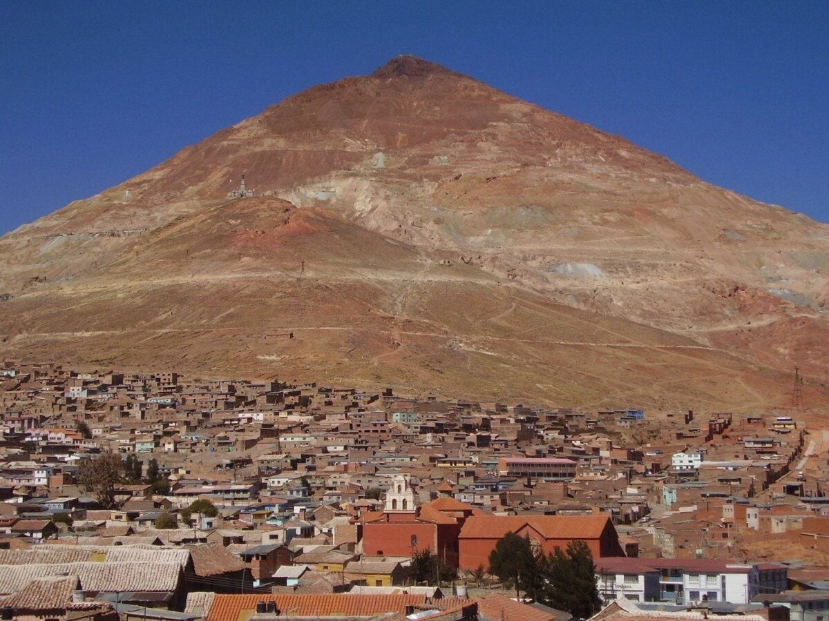 Panoramic view of Potosí with the red cone of Cerro Rico rising behind colonial rooftops