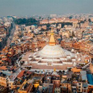 Panoramic view of snow-capped Himalayan peaks at sunrise above terraced hillsides in Nepal