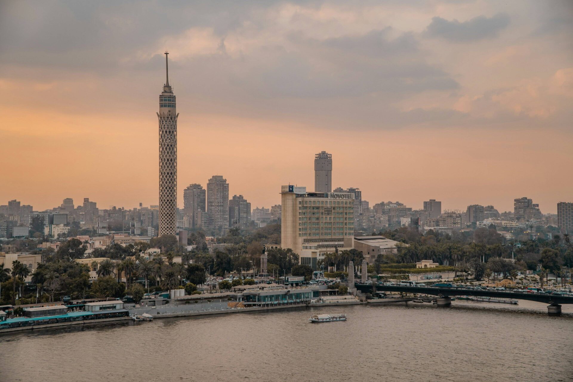 Panoramic view of the Giza Pyramids and the Great Sphinx near Cairo at sunset with warm golden light