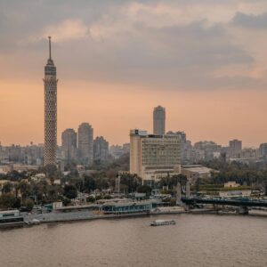 Panoramic view of the Giza Pyramids and the Great Sphinx near Cairo at sunset with warm golden light