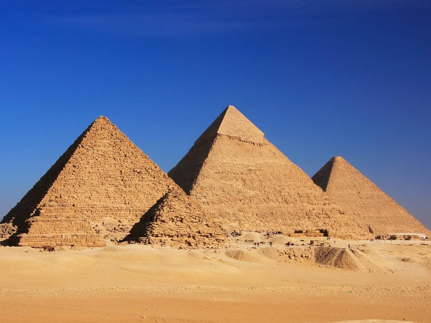 Panoramic view of the Giza Pyramids and the Great Sphinx under a clear blue sky near Cairo, Egypt