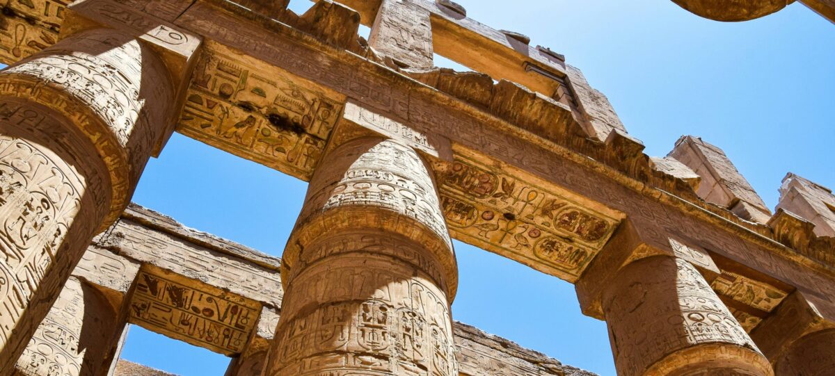 Panoramic view of the Valley of the Kings with desert cliffs and tomb entrances under a clear blue sky