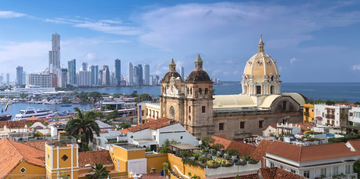 Panoramic view over Cartagena de Indias with colorful colonial houses, church towers and the Caribbean Sea in the background at sunset