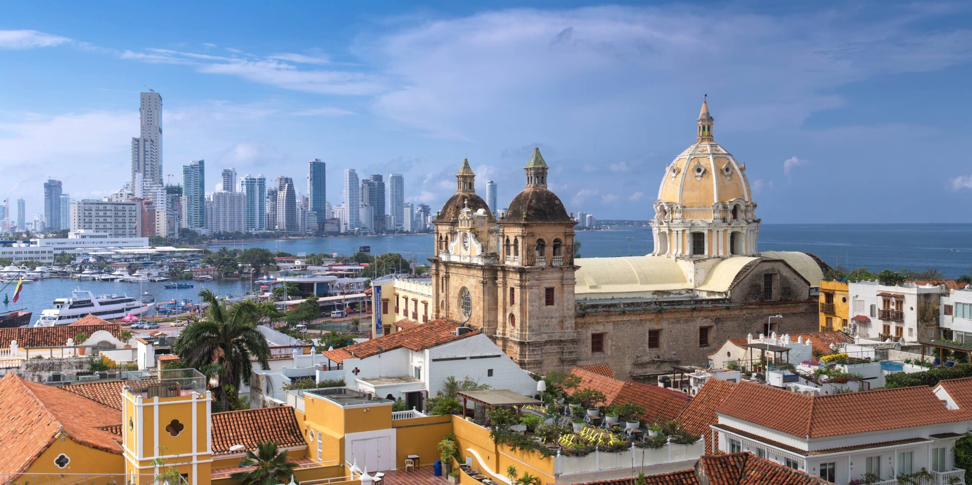 Panoramic view over Cartagena de Indias with colorful colonial houses, church towers and the Caribbean Sea in the background at sunset