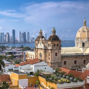Panoramic view over Cartagena de Indias with colorful colonial houses, church towers and the Caribbean Sea in the background at sunset
