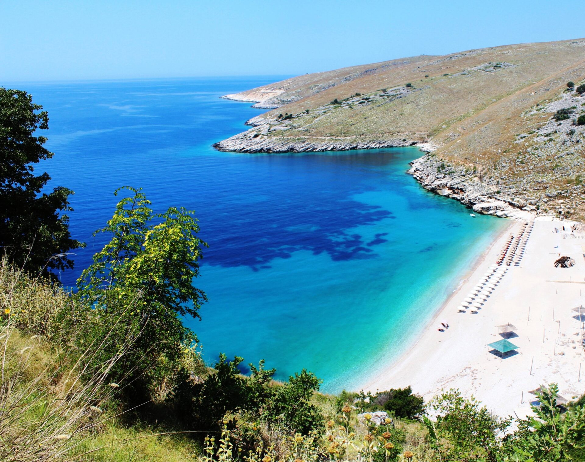 Panoramic view over Tirana with colorful buildings and surrounding hills at sunset in Albania