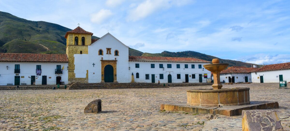 Panoramic view over Villa de Leyva’s vast cobbled Plaza Mayor framed by white colonial buildings