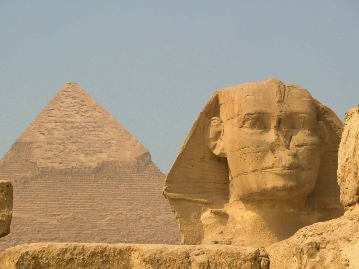 Passenger aircraft taking off from Cairo International Airport with desert landscape below