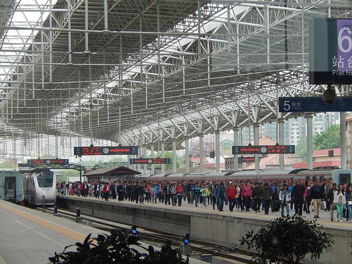 Passenger aircraft taxiing on the runway at sunrise, symbolizing departure from Beijing