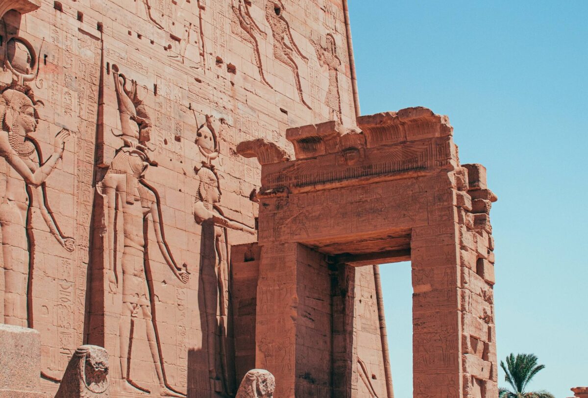 Philae Temple of Isis on an island in the Nile surrounded by blue water and rocky hills