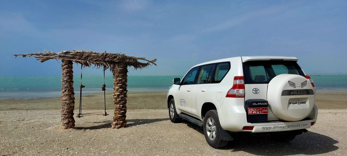 Pristine white-sand beach on Masirah Island with turquoise sea and gentle waves