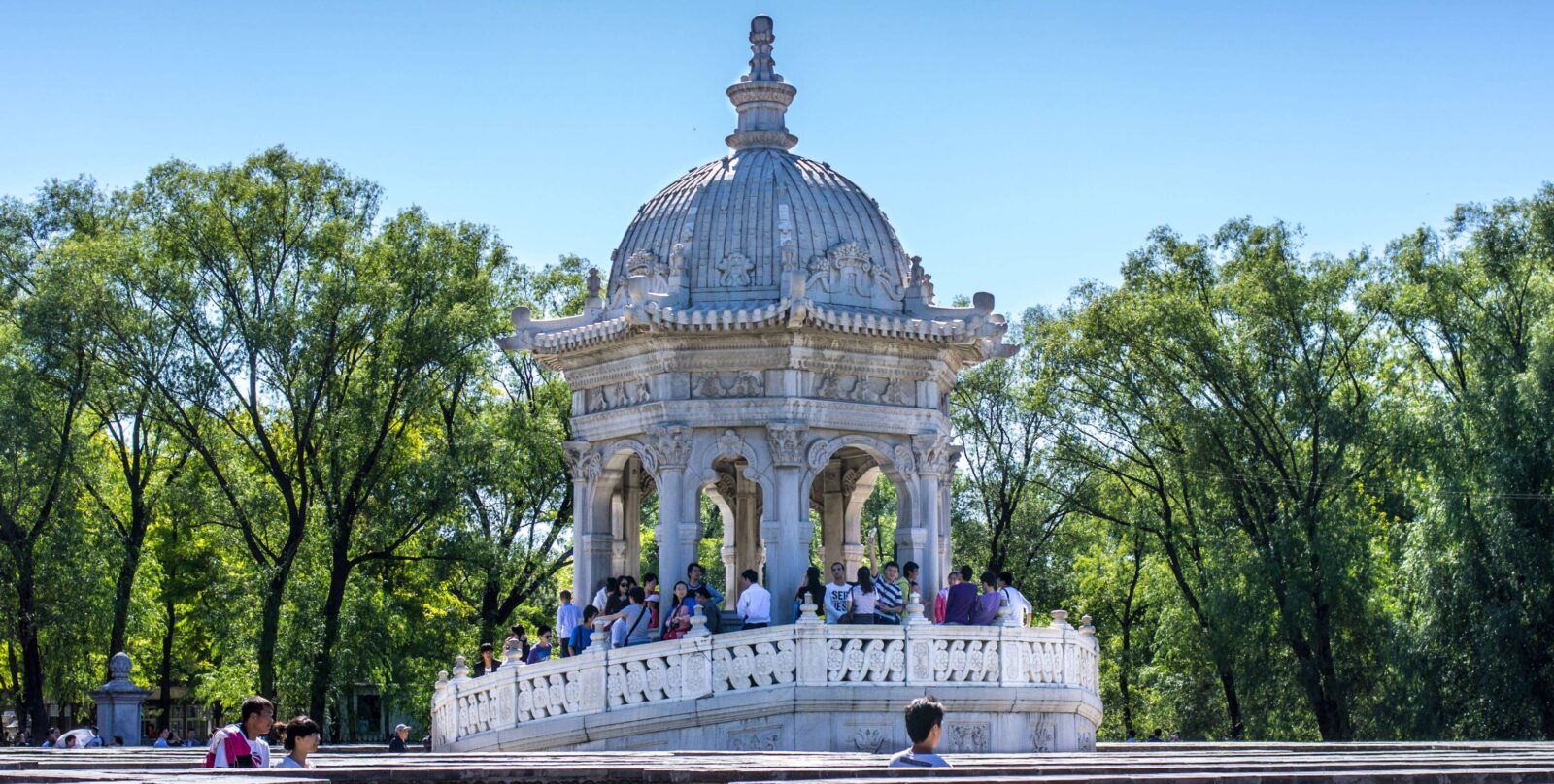 Traditional pavilions and arched bridge of the Summer Palace reflected in Kunming Lake in Beijing