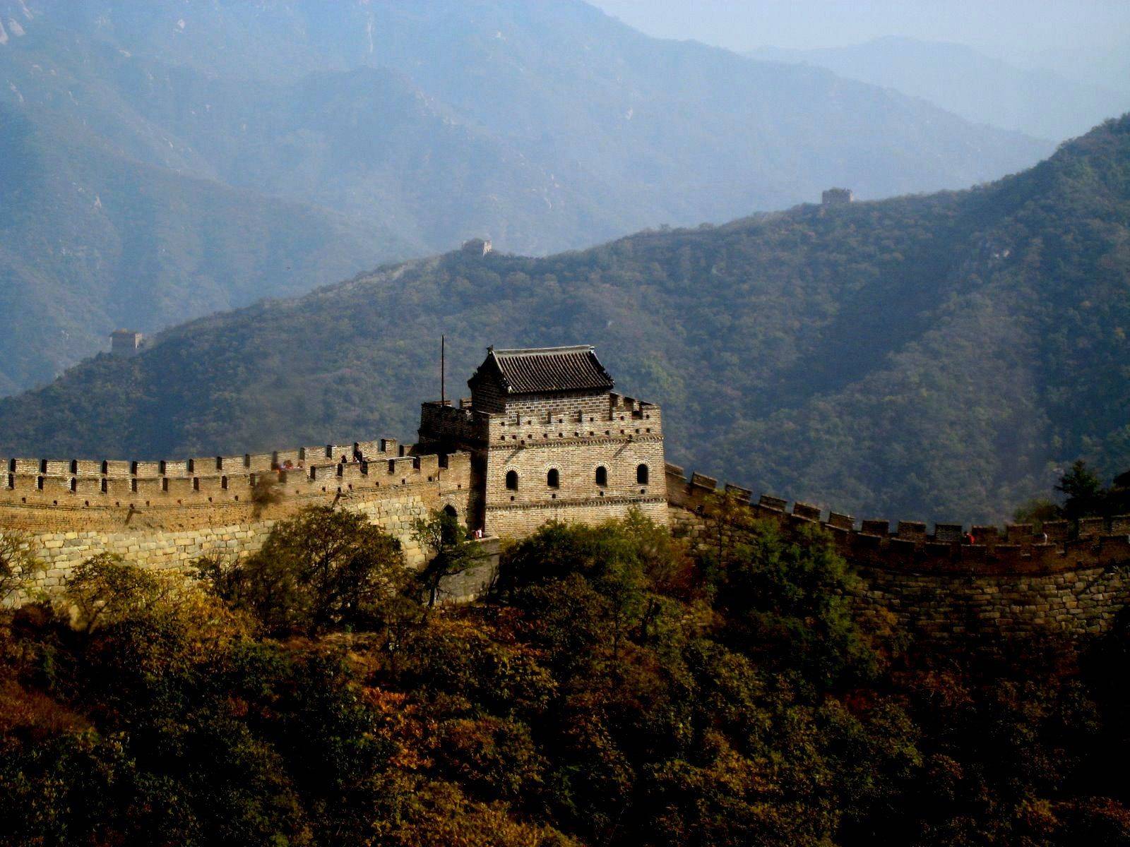 Passenger jet taking off from Beijing airport against a hazy city backdrop