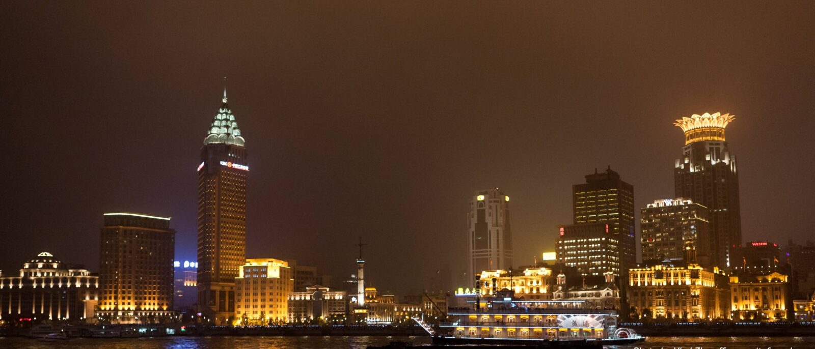Shanghai skyline viewed from the Bund with historic waterfront buildings and modern skyscrapers across the river