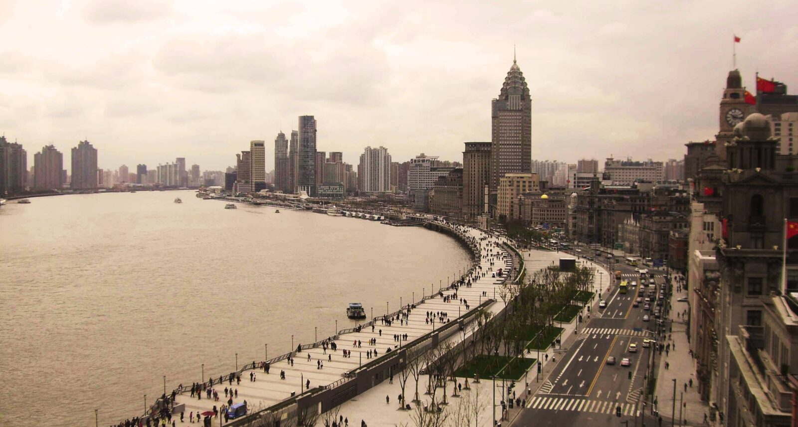 Departure hall of Shanghai airport with travelers walking through a bright modern terminal