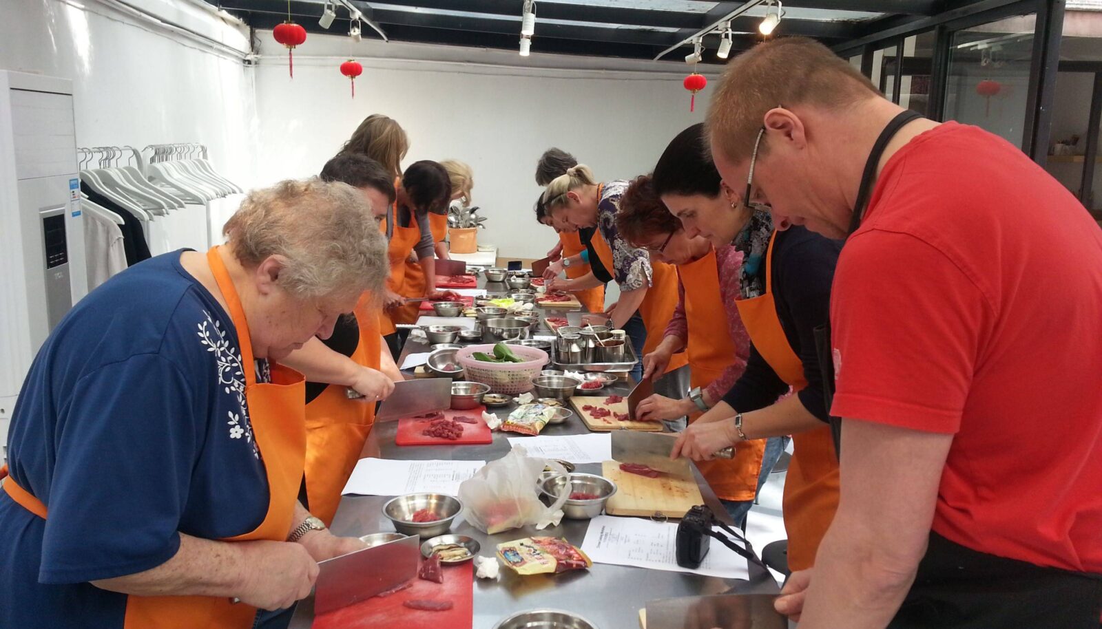 Tai Chi instructor guiding a small group of travelers in slow movements in a leafy Shanghai city park