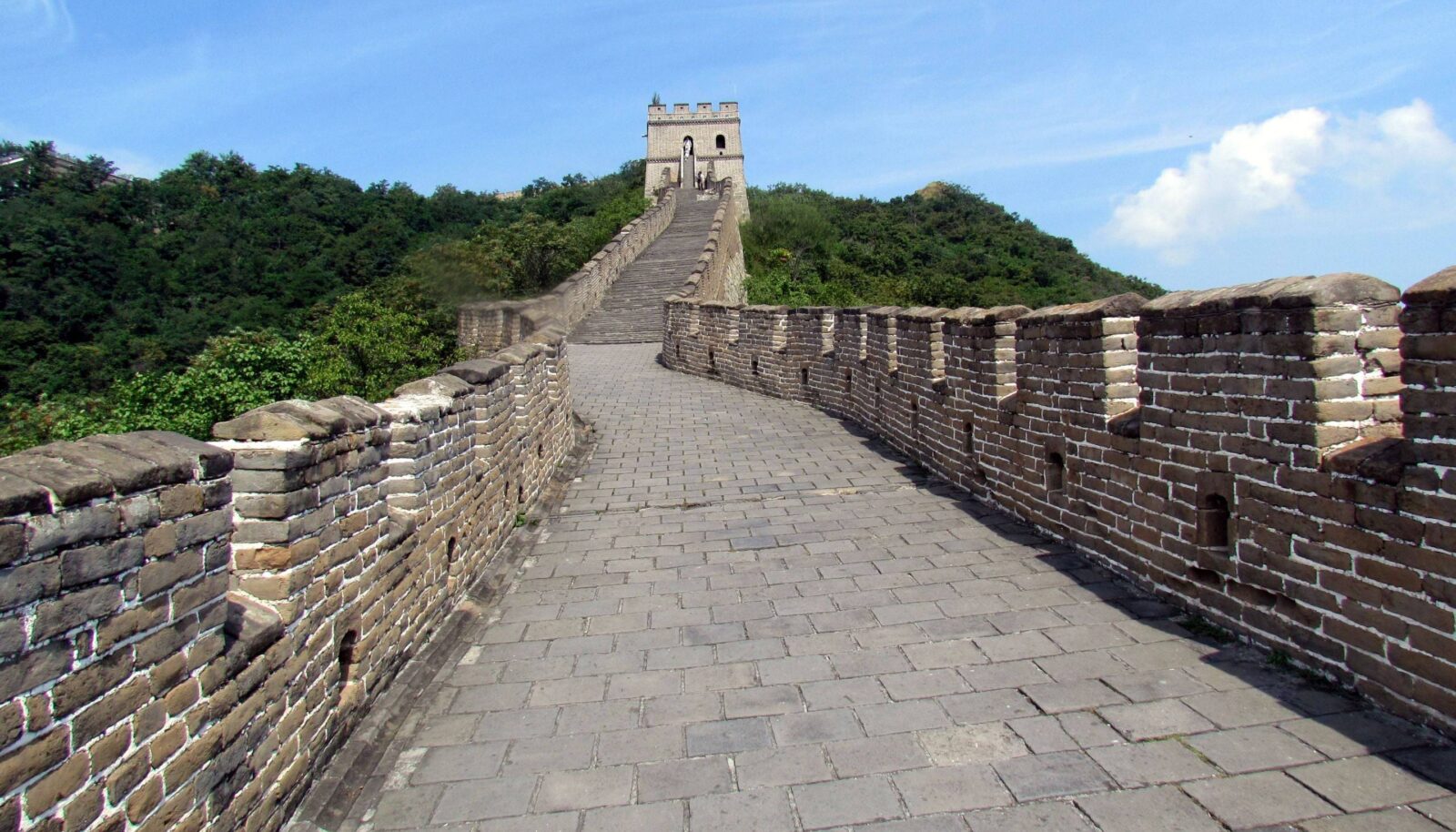 Family with small children walking along a restored section of the Great Wall at Mutianyu on a clear day