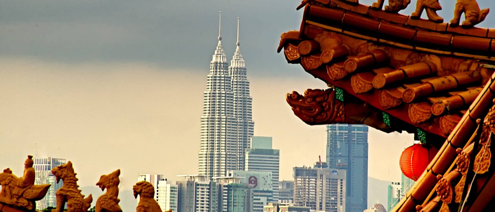 Night view of Kuala Lumpur skyline with illuminated Petronas Twin Towers and city lights