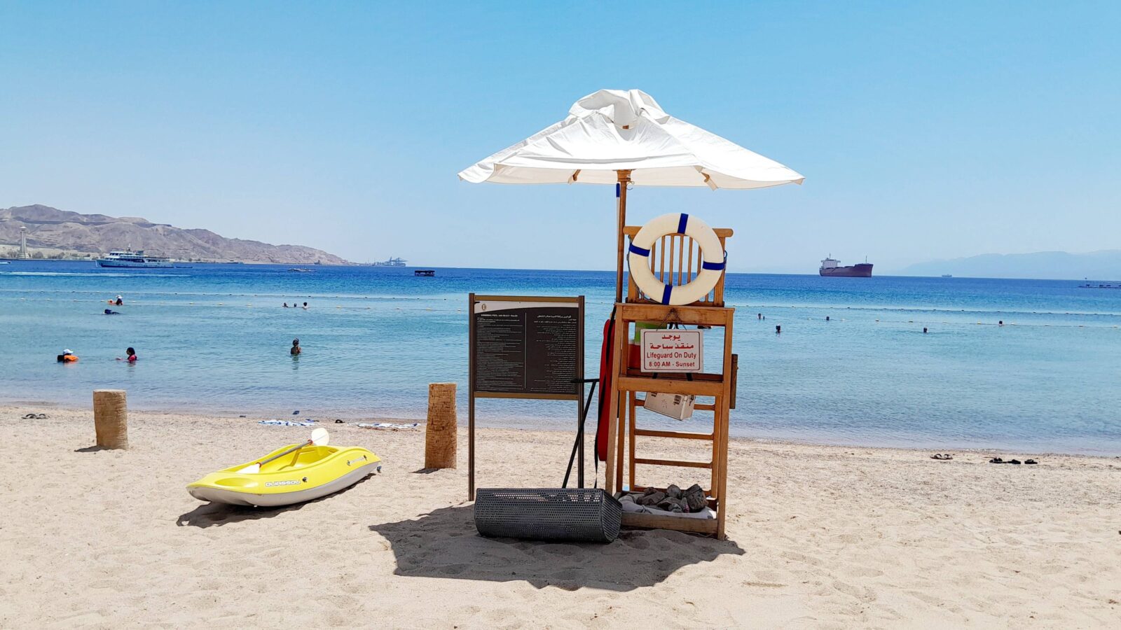 Family walking through the red rock canyon of Petra in Jordan, with sunlight illuminating the carved stone façade in the distance
