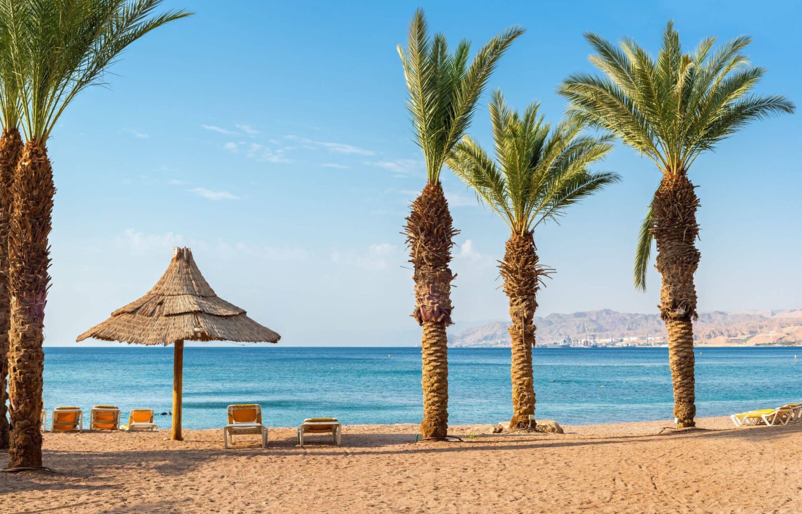 Children snorkelling in the clear blue waters of the Red Sea near Aqaba above colourful coral reefs