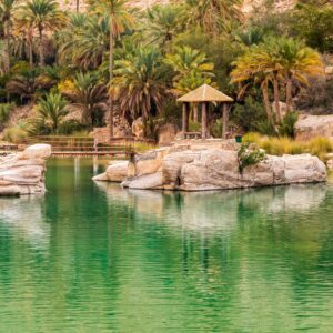 Panoramic view over the rugged cliffs and deep canyon of Jabal Shams in northern Oman under a clear blue sky