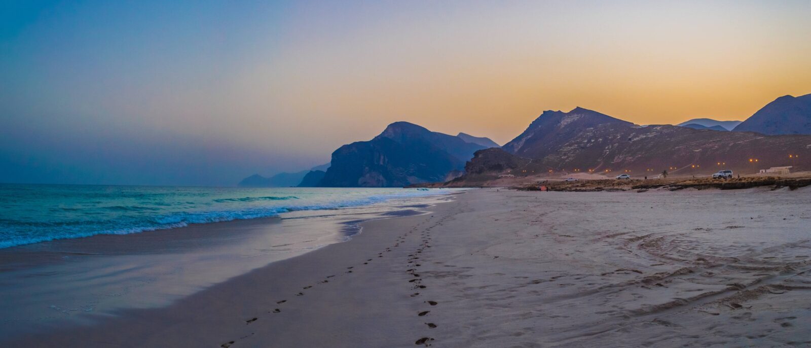 Sandy bay and rocky headlands near Ras Al Jinz on the eastern coast of Oman at sunset