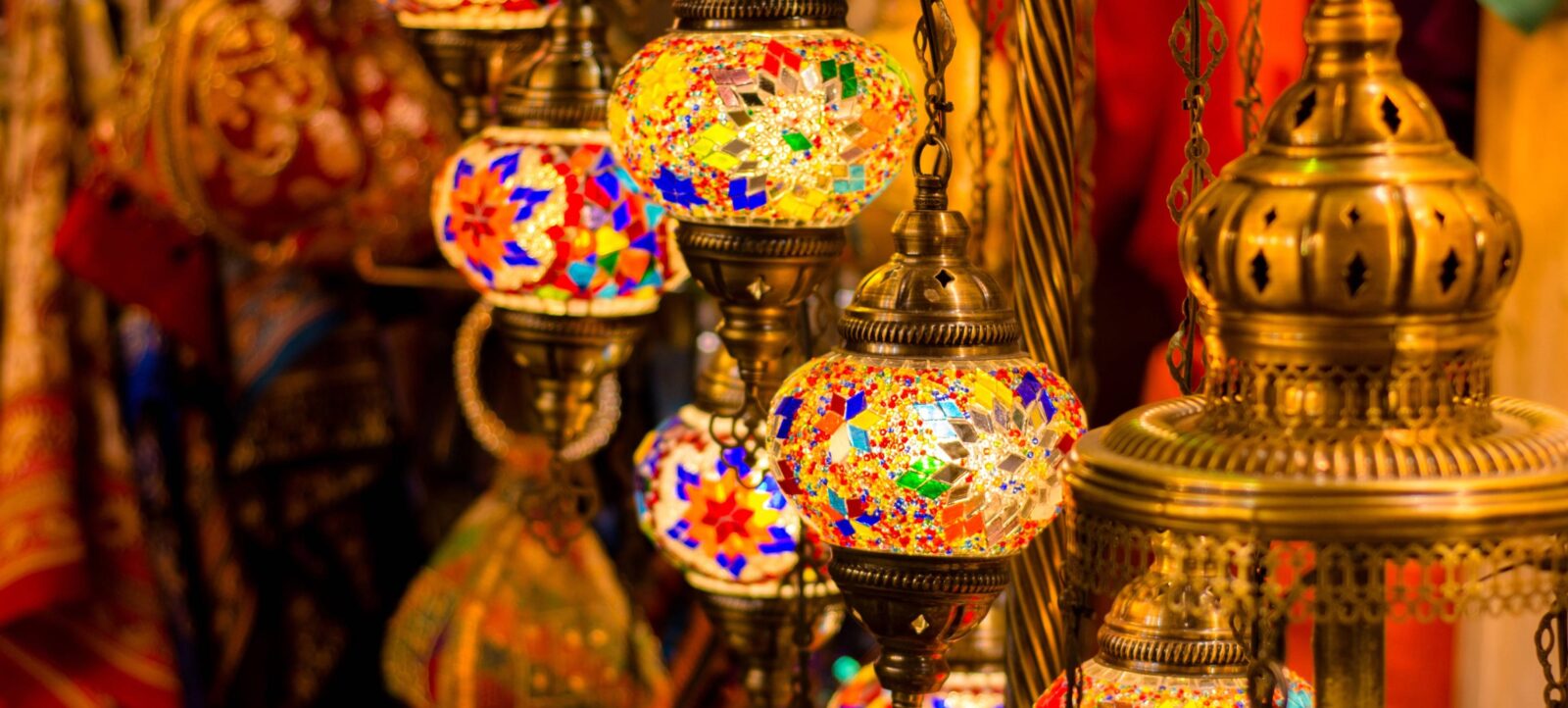 Sultan Qaboos Grand Mosque and surrounding gardens in Muscat, Oman, under a clear blue sky
