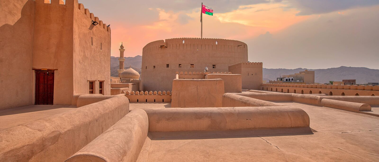 Nizwa Fort in Oman with its round tower and surrounding oasis town