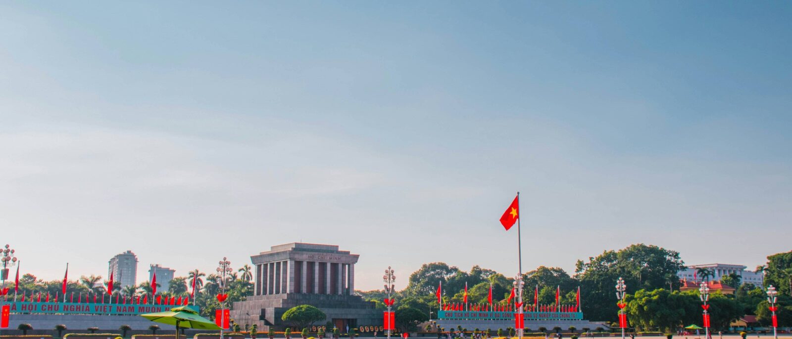 Cyclo rickshaws passing colonial buildings and lakes during a city tour of Hanoi