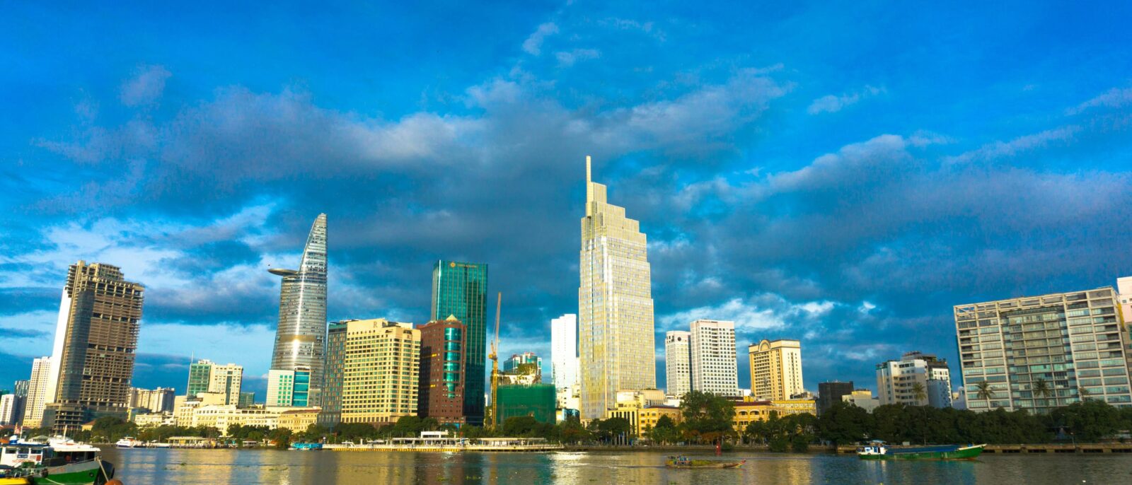 Notre Dame Cathedral and Central Post Office in Ho Chi Minh City on a sunny day with traffic passing by