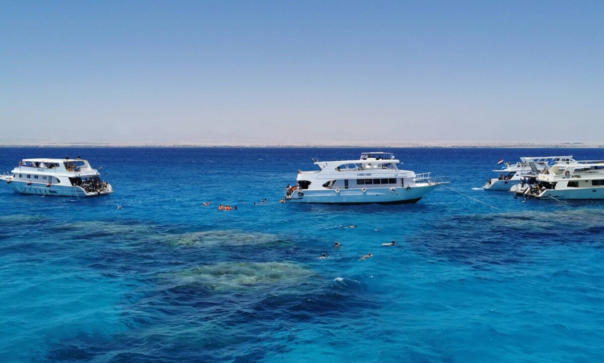 Quad bikes driving across the sandy desert near Hurghada at sunset