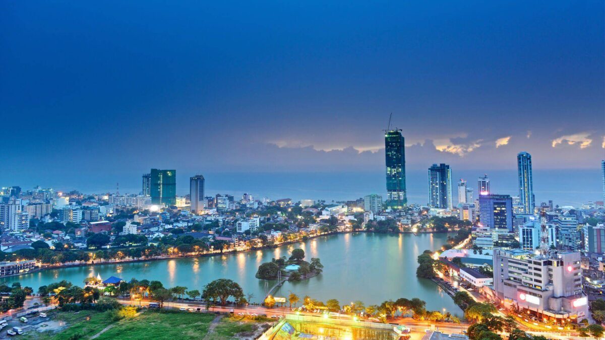 Skyline and historic buildings of central Colombo, Sri Lanka, seen from the waterfront at sunset