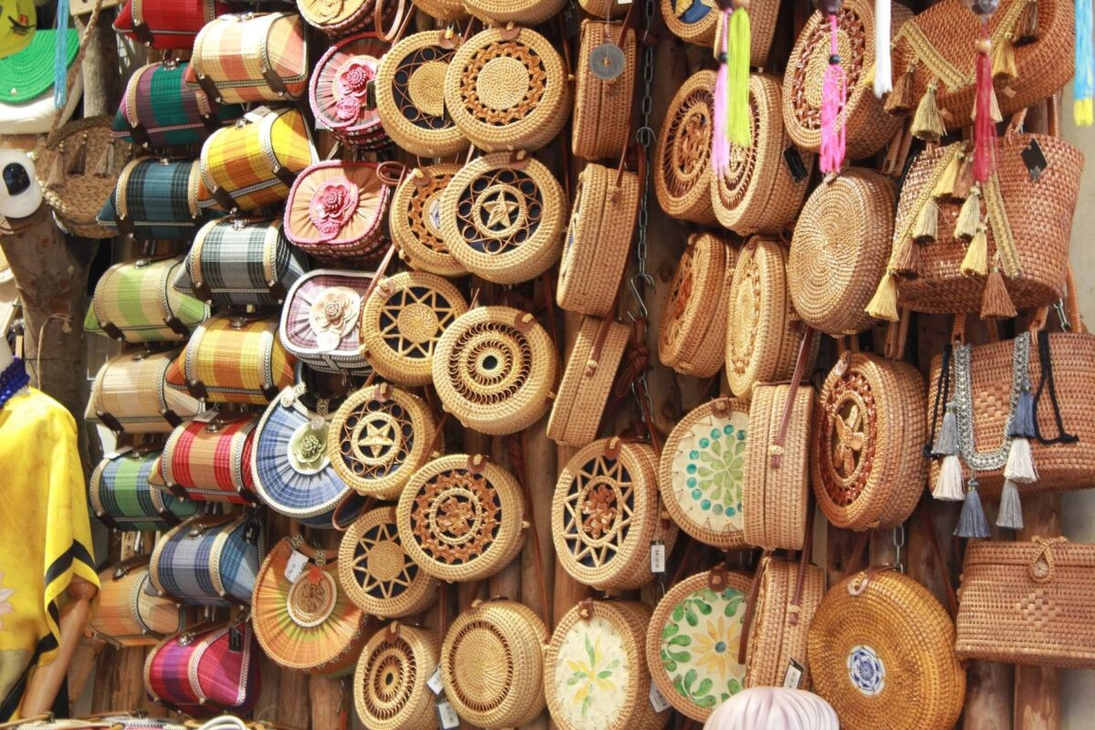 Small wooden boat navigating a narrow palm-lined canal in the Mekong Delta near Cai Be, Vietnam