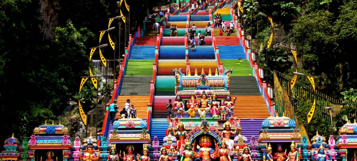 Steep staircase and golden Lord Murugan statue at Batu Caves in Malaysia