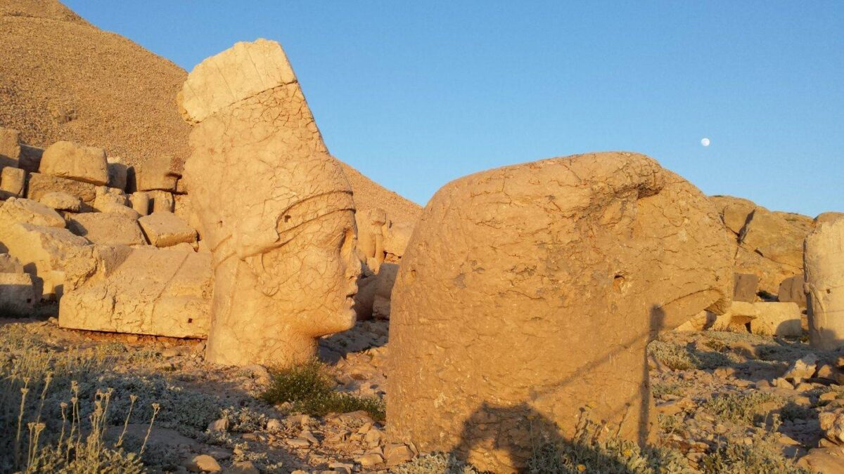 Stone heads and statues at the summit of Mount Nemrut in Eastern Turkey at sunset
