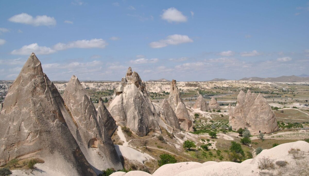 Stone houses and narrow streets of Mustafapasha village surrounded by Cappadocia’s rolling valleys