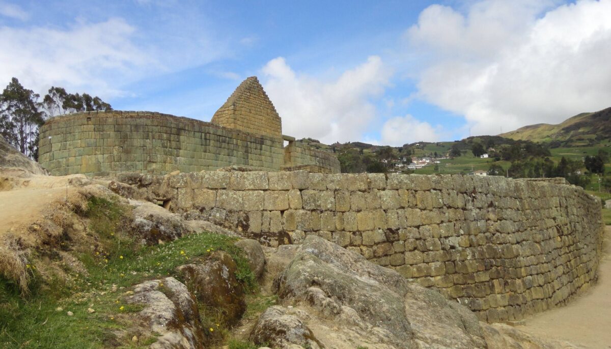 Stone temple and terraces of the Ingapirca Inca ruins set against rolling Andean hills