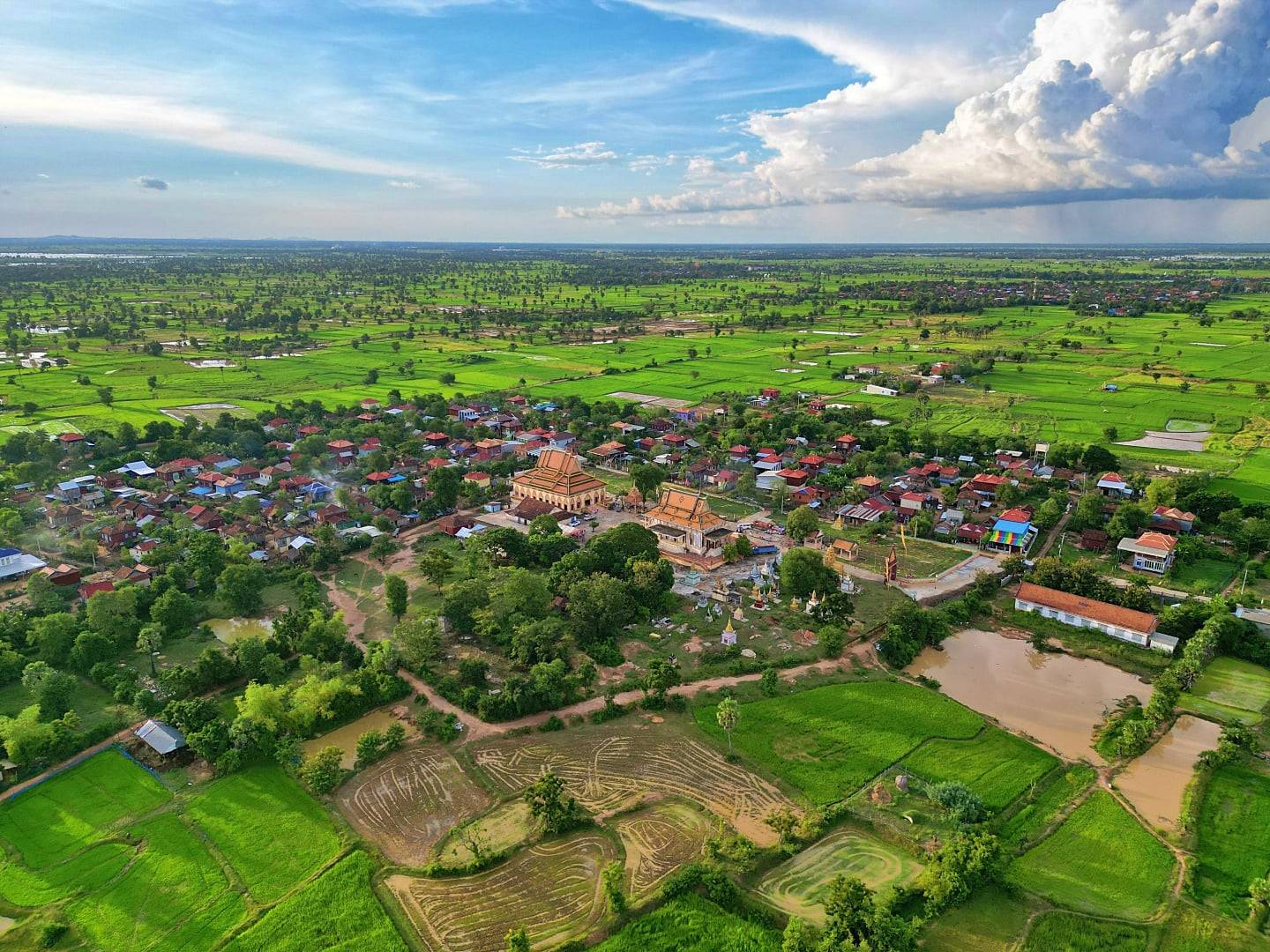 Stone towers and intricate carvings of Angkor Wat temple complex in Cambodia at sunrise, reflected in a lotus pond