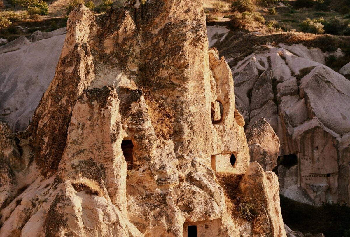 Straight road crossing a semi-arid plateau in Cappadocia leading towards distant hills
