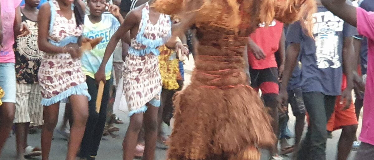 Street carnival procession with colourful costumes and calabash decorations at the Calabash Festival