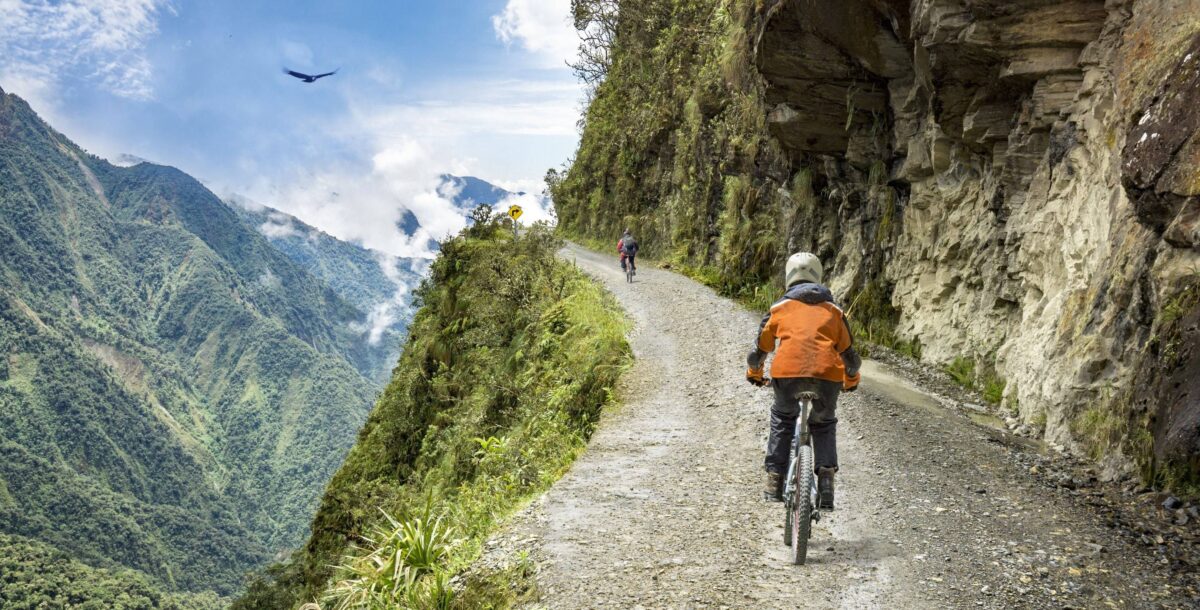 Street scene in La Paz with colorful houses climbing the hillsides and locals walking past market stalls