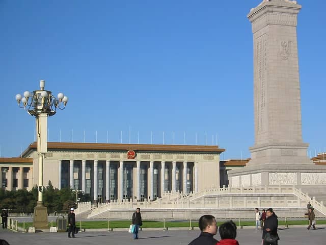 Temple of Heaven in Beijing with blue-tiled circular hall and visitors in the surrounding park