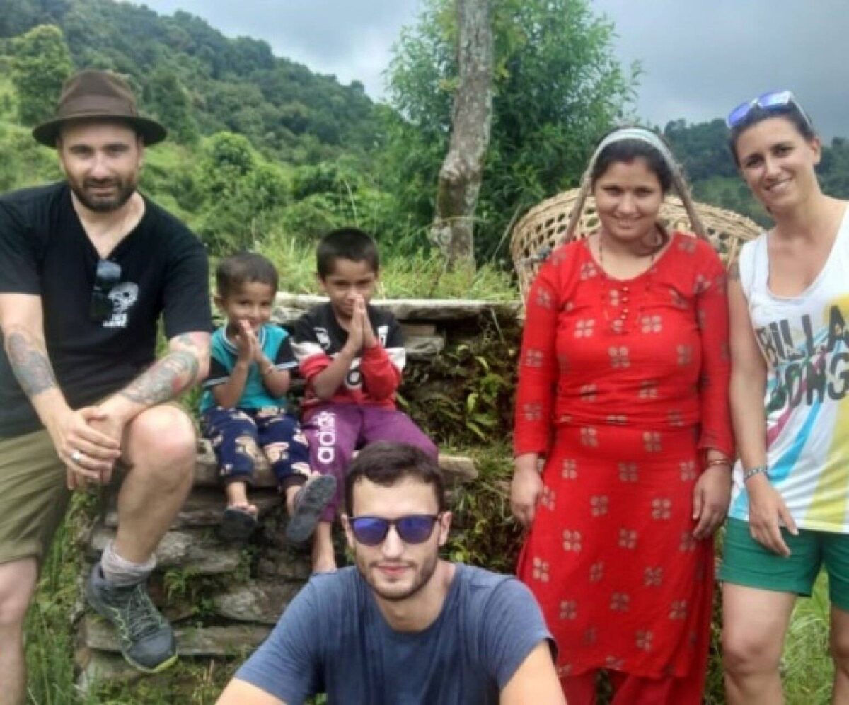 Terraced fields and traditional homes in Astam village with Annapurna peaks rising in the distance