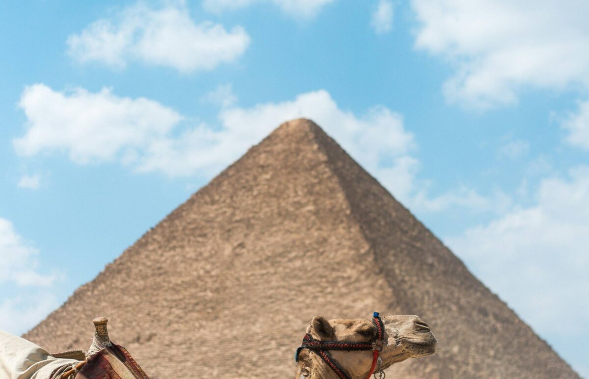 The Great Pyramid of Giza with the Sphinx in the foreground under a sunny sky